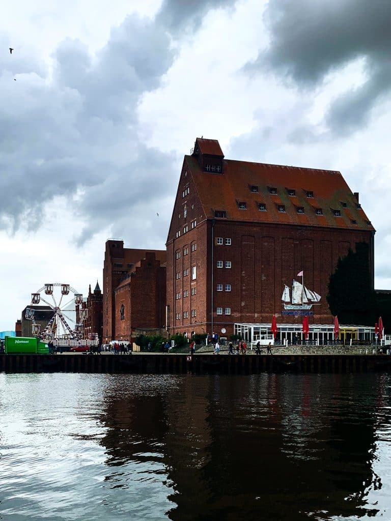 Backsteinspeicher im Stralsunder Hafen, der sich im Wasser spiegelt